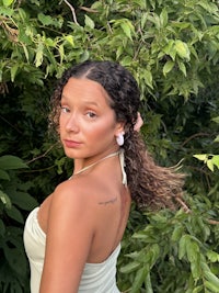 a woman in a green dress posing in the woods