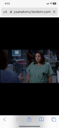 a picture of a woman in scrubs talking to someone