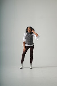 young african american woman listening to music while sitting on the floor