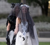 two women dressed in costumes walking down the street