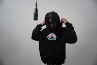 a man with dreadlocks is holding a microphone