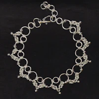a silver bracelet with a circular design