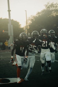 a group of football players running on a field