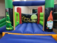 a large inflatable bounce castle with a christmas theme