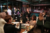 a group of people sitting at a table in a restaurant