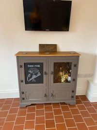 a wooden cabinet with a tv on top of it