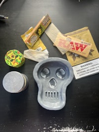 a skull shaped ash tray and other items on a table