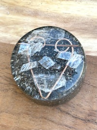 a heart shaped stone on a wooden table