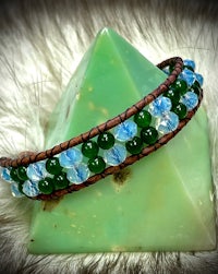 a bracelet with green and blue beads on it