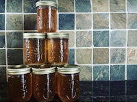 five jars of honey stacked on top of each other