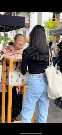 a woman is standing next to a woman at a booth