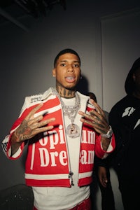 a man in a red and white jacket is standing next to another man