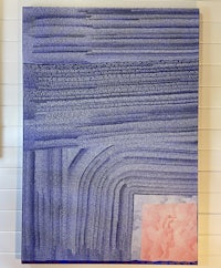 a blue and pink painting hanging on a wall