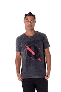 a man wearing a grey t - shirt with a red lightning bolt on it