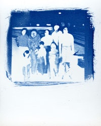 a blue and white photo of a group of people