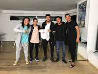 a group of men posing for a picture in a living room