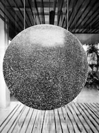 a black and white photograph of a large stone in a glass display