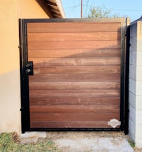 a wooden gate in front of a house