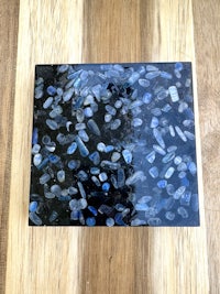 a black and blue tile on a wooden table