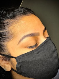 a woman wearing a black face mask