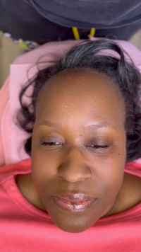 a woman is lying on a bed with her eyes closed