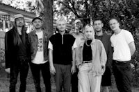 a black and white photo of a group of people standing together