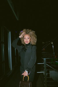 a woman with a curly afro posing for a photo