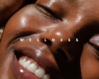 a woman smiling with the words wellness on her face