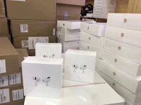 apple airpods in boxes on a table in a warehouse