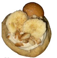 a banana cookie topped with whipped cream and nuts