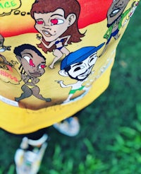 a person wearing a t - shirt with cartoon characters on it