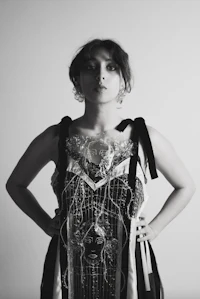 a black and white photo of a woman in a dress