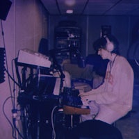 a man is playing a keyboard in a room