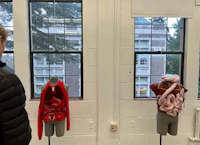 a man looking at mannequins in a room