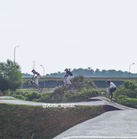 a group of people doing a trick on their bikes