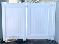 a white fence with a white gate on it