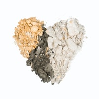 a heart shaped pile of white, yellow, and brown eyeshadow