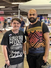 two men standing next to each other at an event