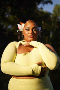 a woman in a yellow dress posing for a photo