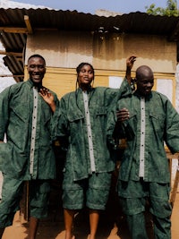 a group of people standing in front of a shack