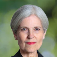 a woman with gray hair and a black jacket