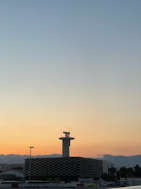 an airport with a tower in the background