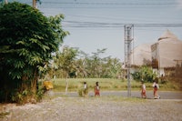 a group of children walking down a street