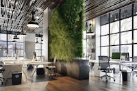 an office with a lot of greenery on the wall