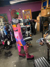 a woman wearing a colorful dress in a shop