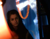 a woman looking at herself in a mirror