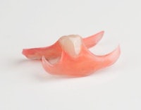a pair of plastic teeth on a white surface