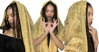 a woman with dreadlocks wearing a yellow shawl