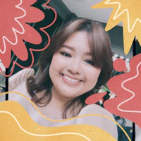 a woman is smiling in front of a colorful background