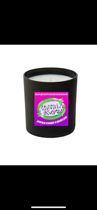a black candle with a purple label on it